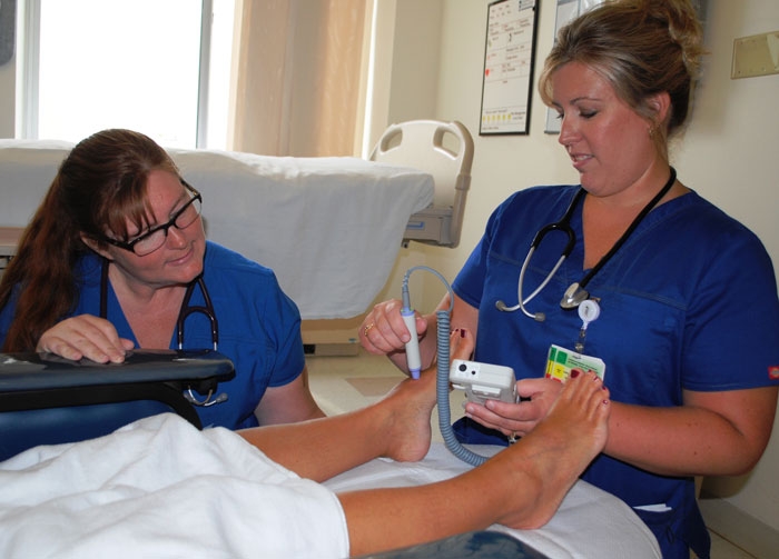 Auxiliary gift supports nursing equipment purchase for UM SMC at Chestertown: Kathy Schlesner, RN, preceptor (right) teaches Melanie Walls, RN, how to use the Vascular Doppler.